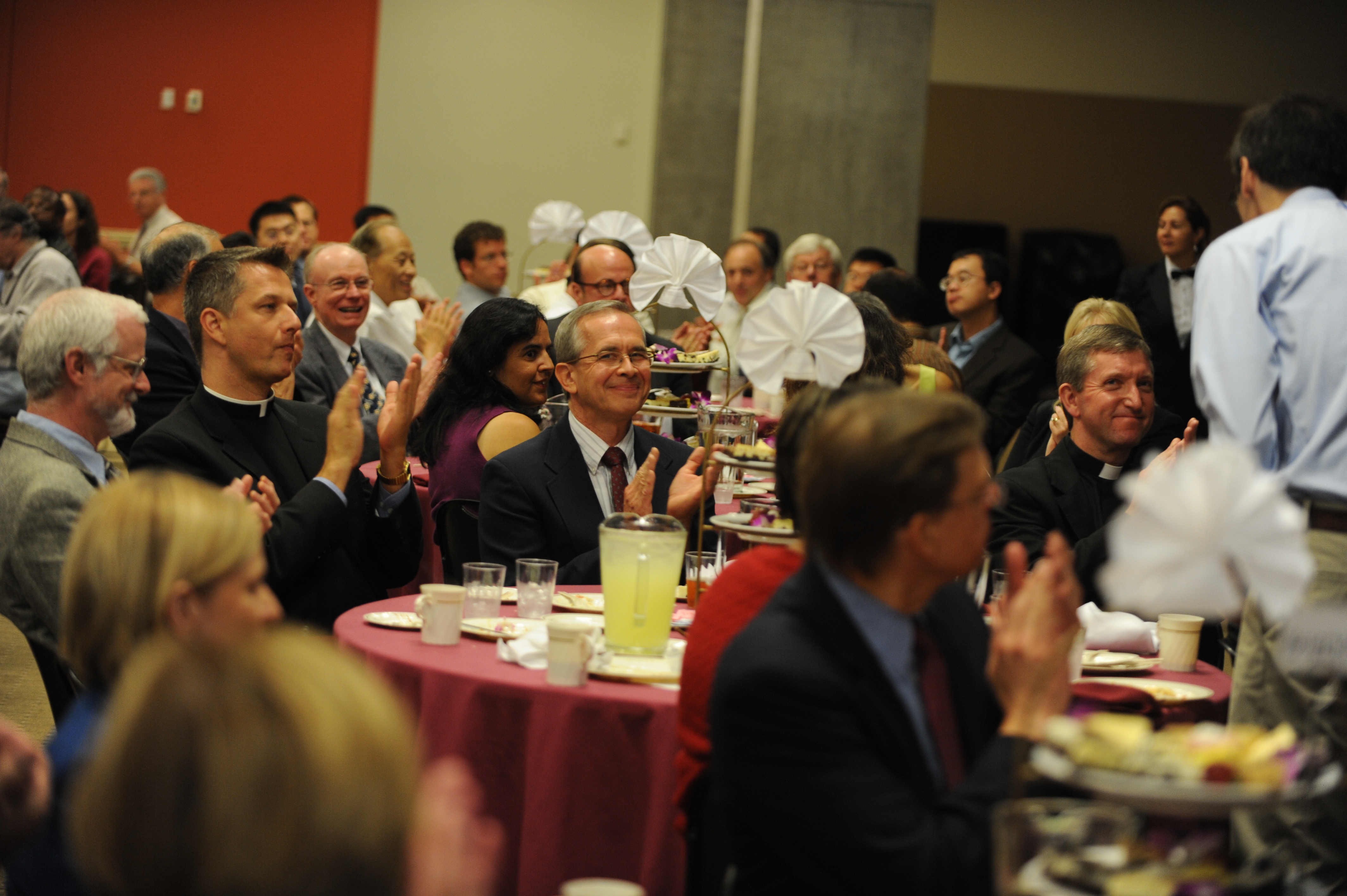 Catholic University faculty and staff are gathered around a table for the Faculty and Staff Welcome Lunch.
