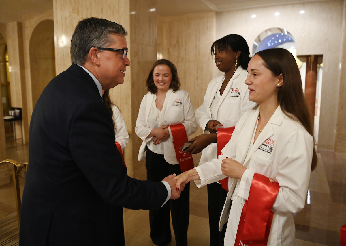 Conway School of Nursing students greet CUA President Peter Kilpatrick. 