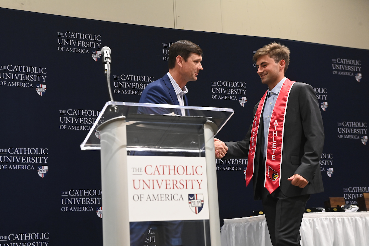 A student receives an award at the Senior Athletics Award. 