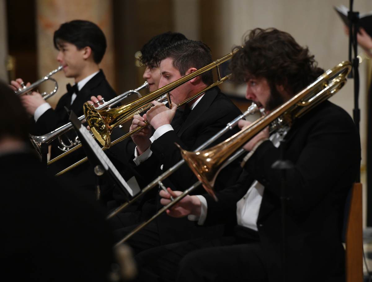 Three Catholic University trombone players perform at a recent concert.