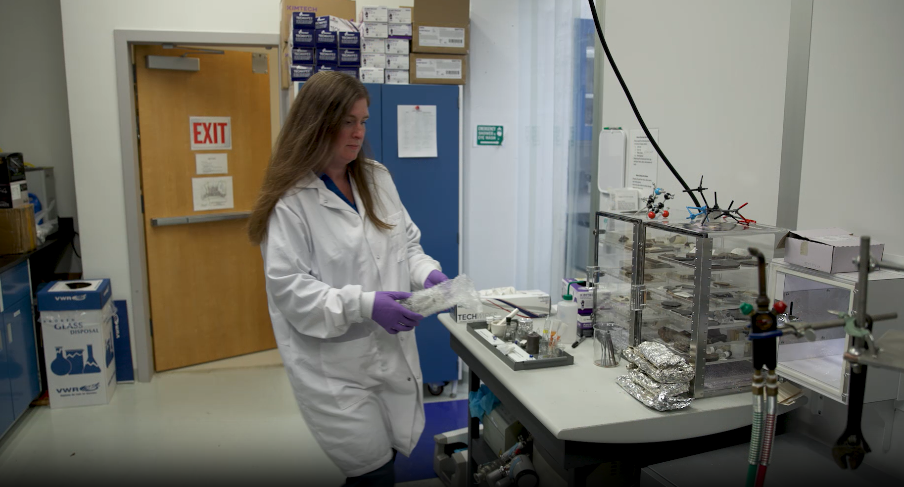 Hannah McLain receives the first sample from space delivered to the lab