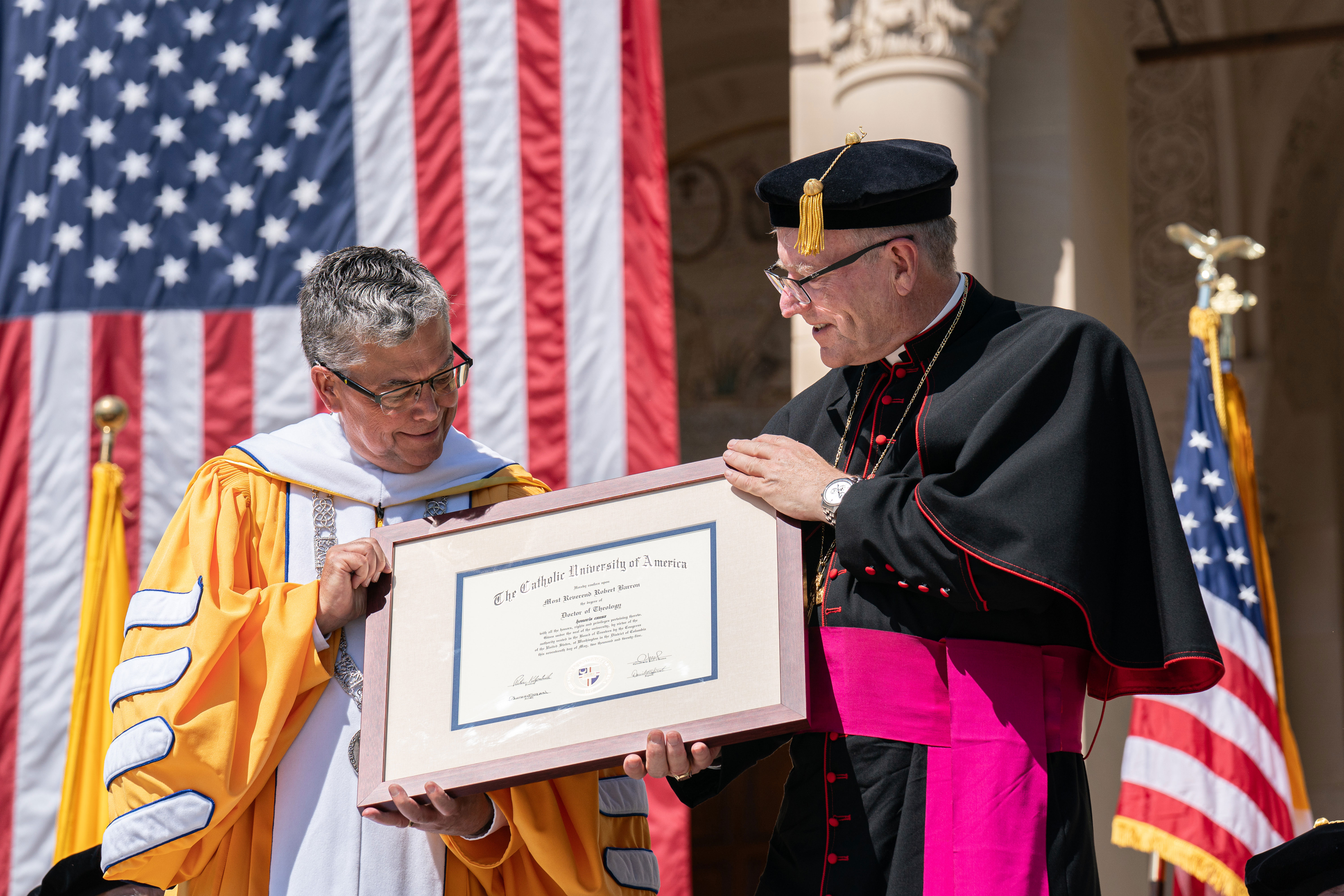 Bishop Barrron accepts his honorary degree from President Kilpatrick.