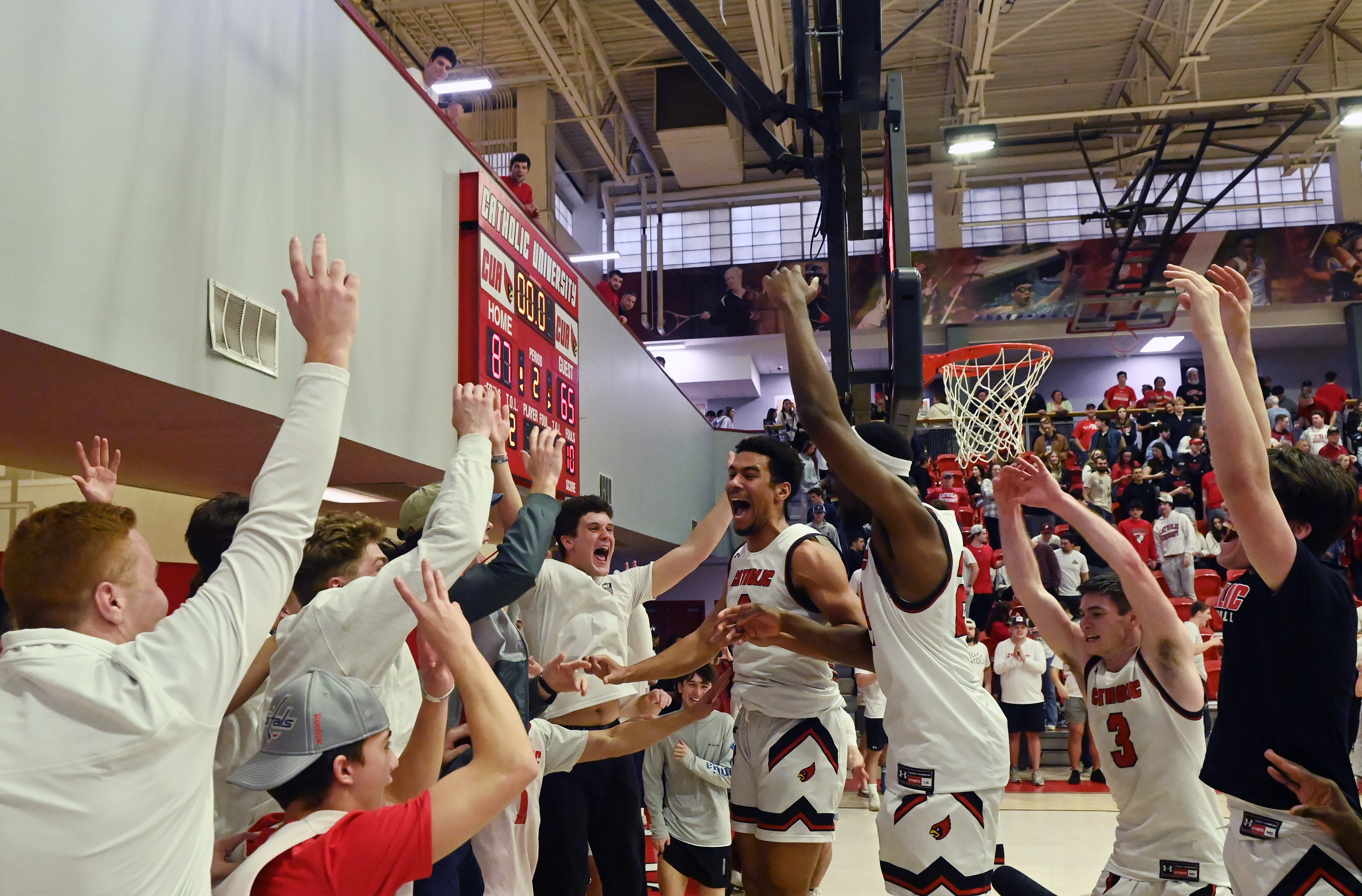 Men's basketball team cheers after big win