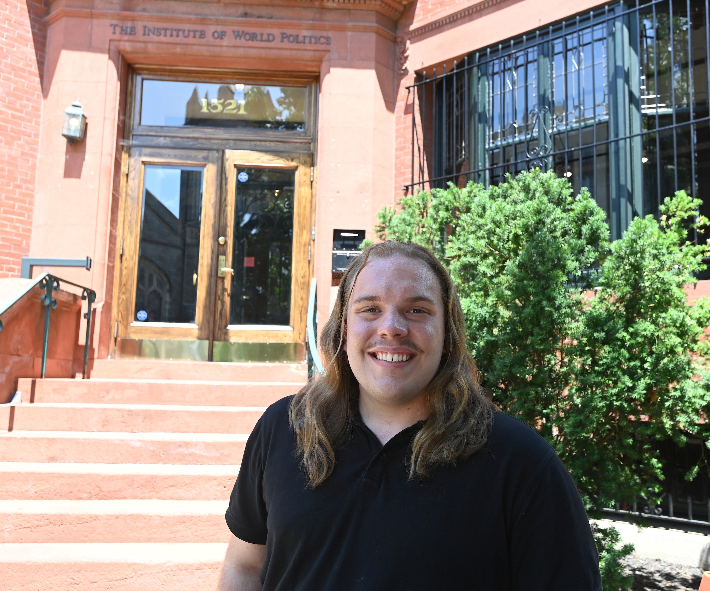 Nathan-Raegan Stickney stands outside The Institute of World Politics