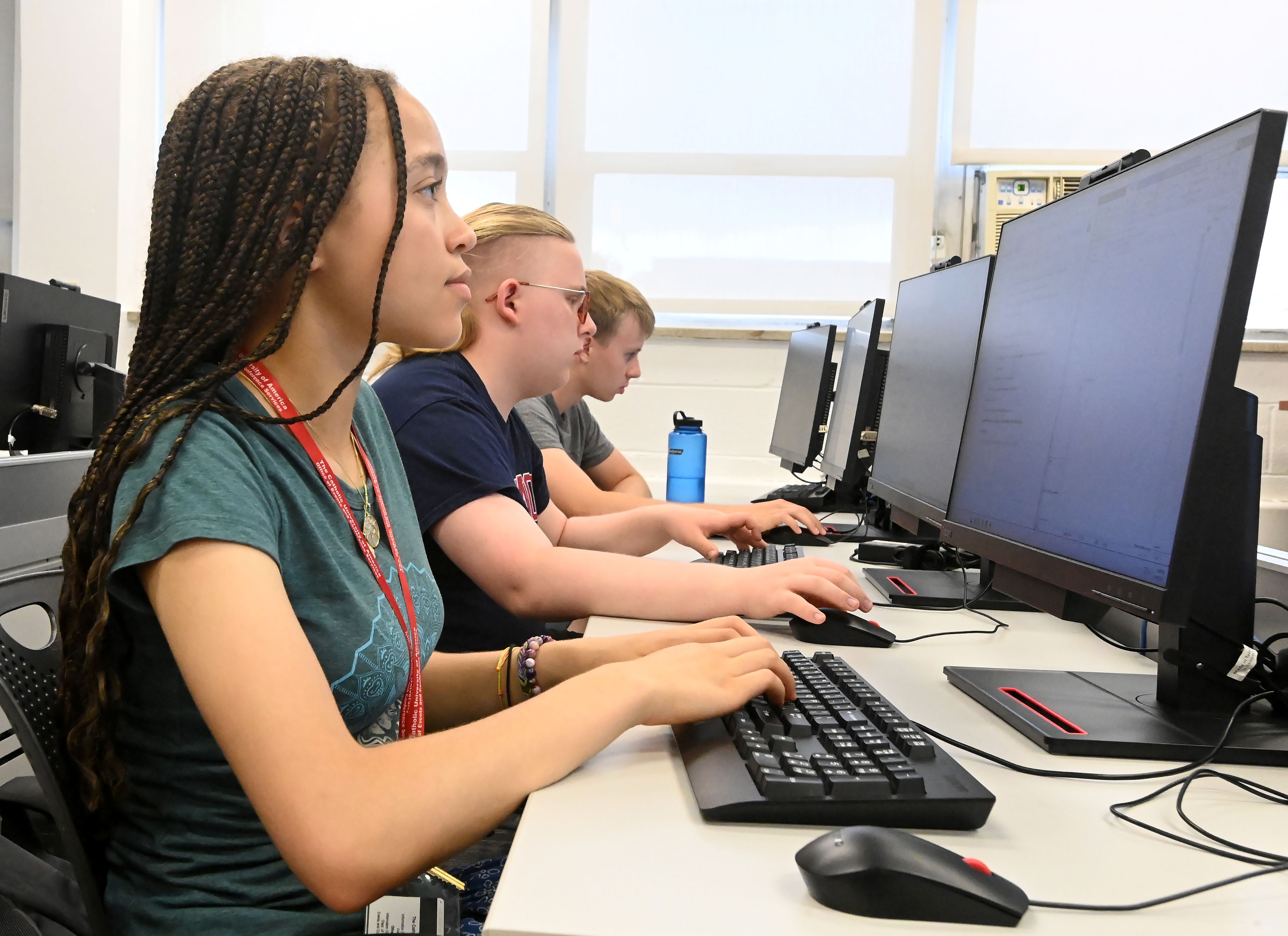computer science students listen to a lecture in a lab