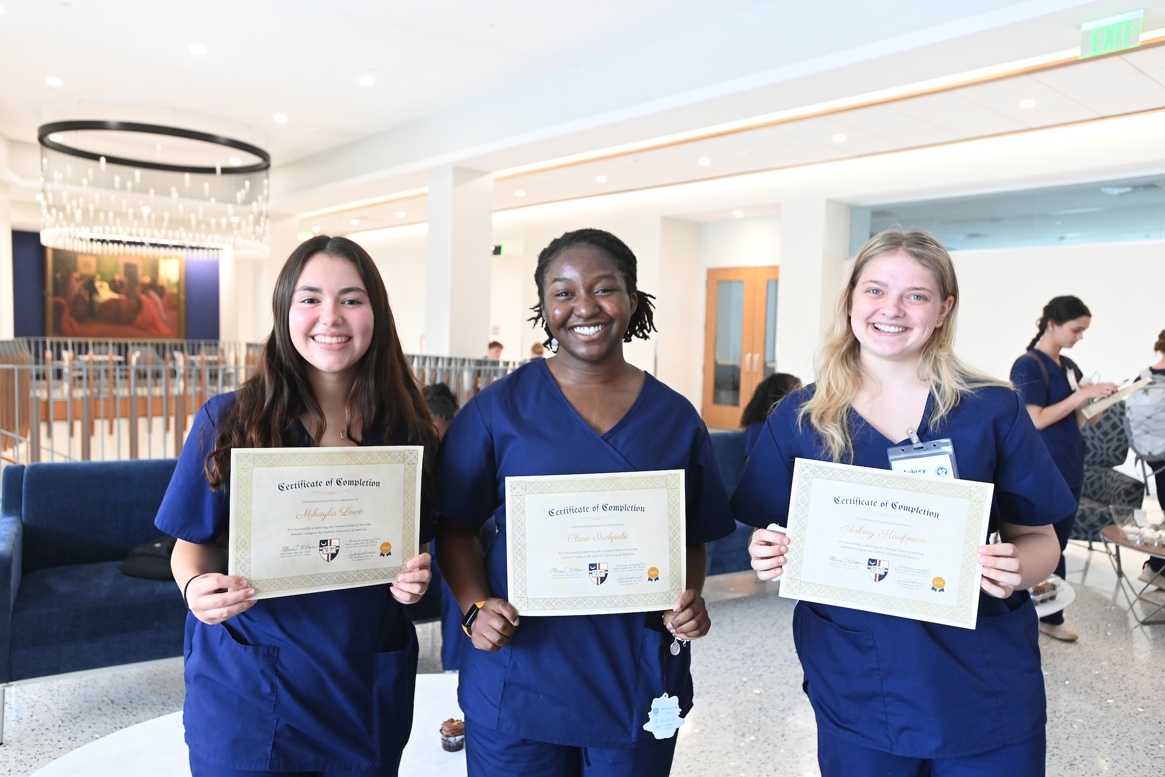 high schoolers receive their certificates of completion from the nursing school summer camp