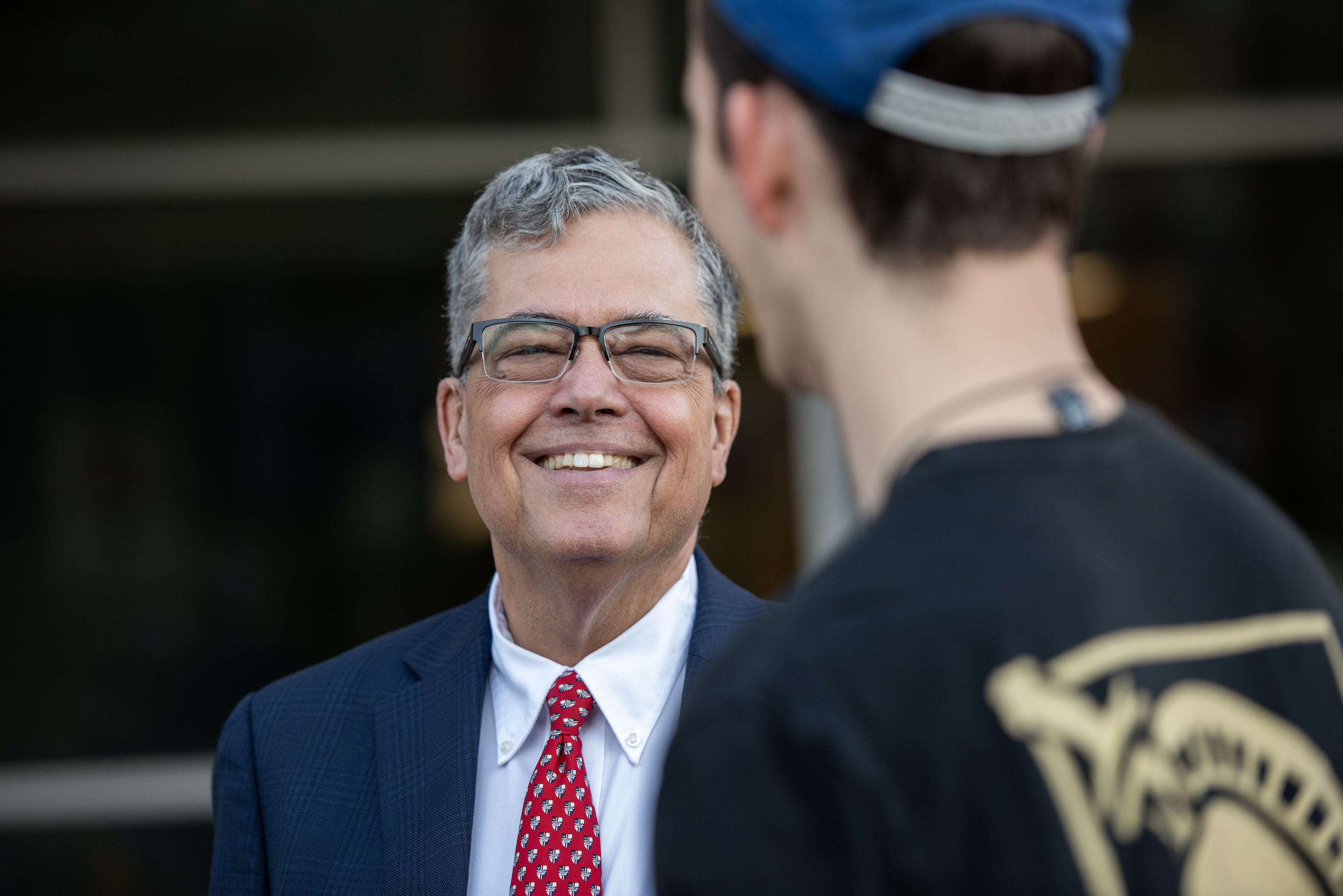 President Kilpatrick smiling while talking to a male student