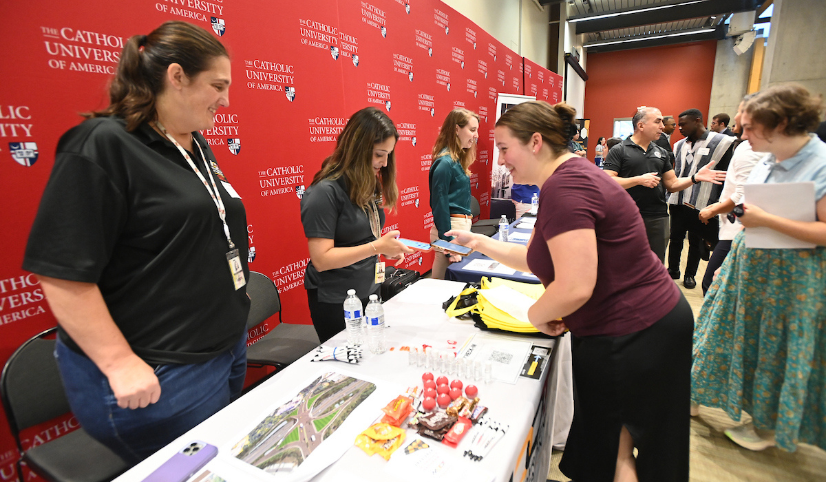 A student is discussing with a potential employer during the Fall Career & Internship Fair.