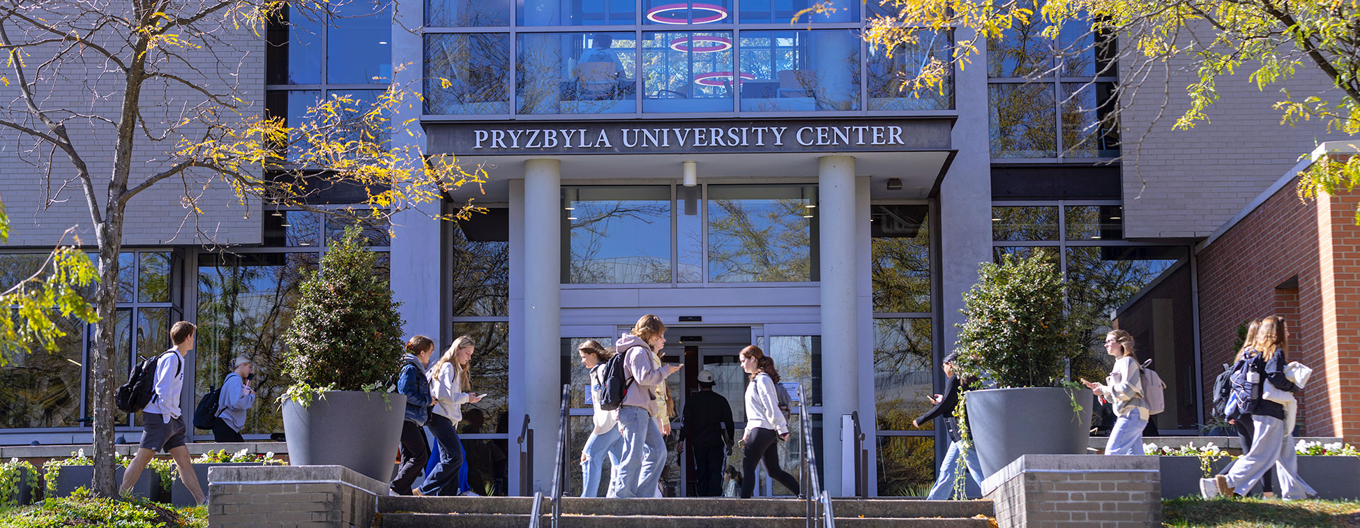 University students walking in front of the Pryz Center.