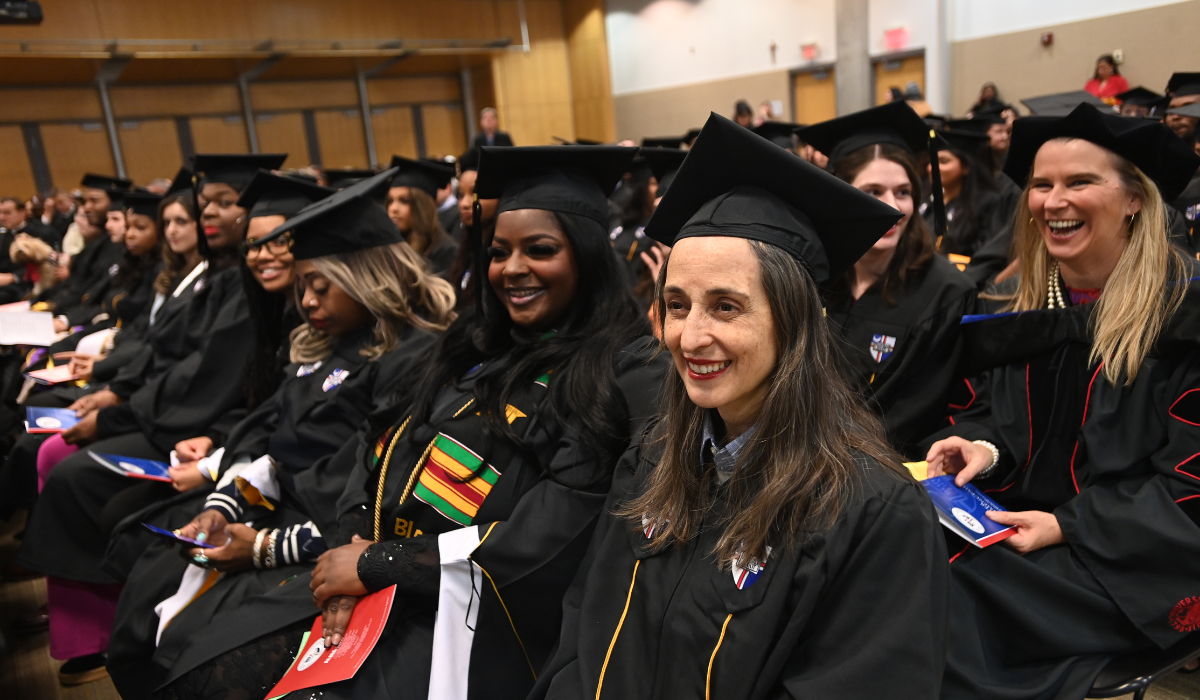 Graduates as Winter Commencement 2025 smiling during the ceremony.