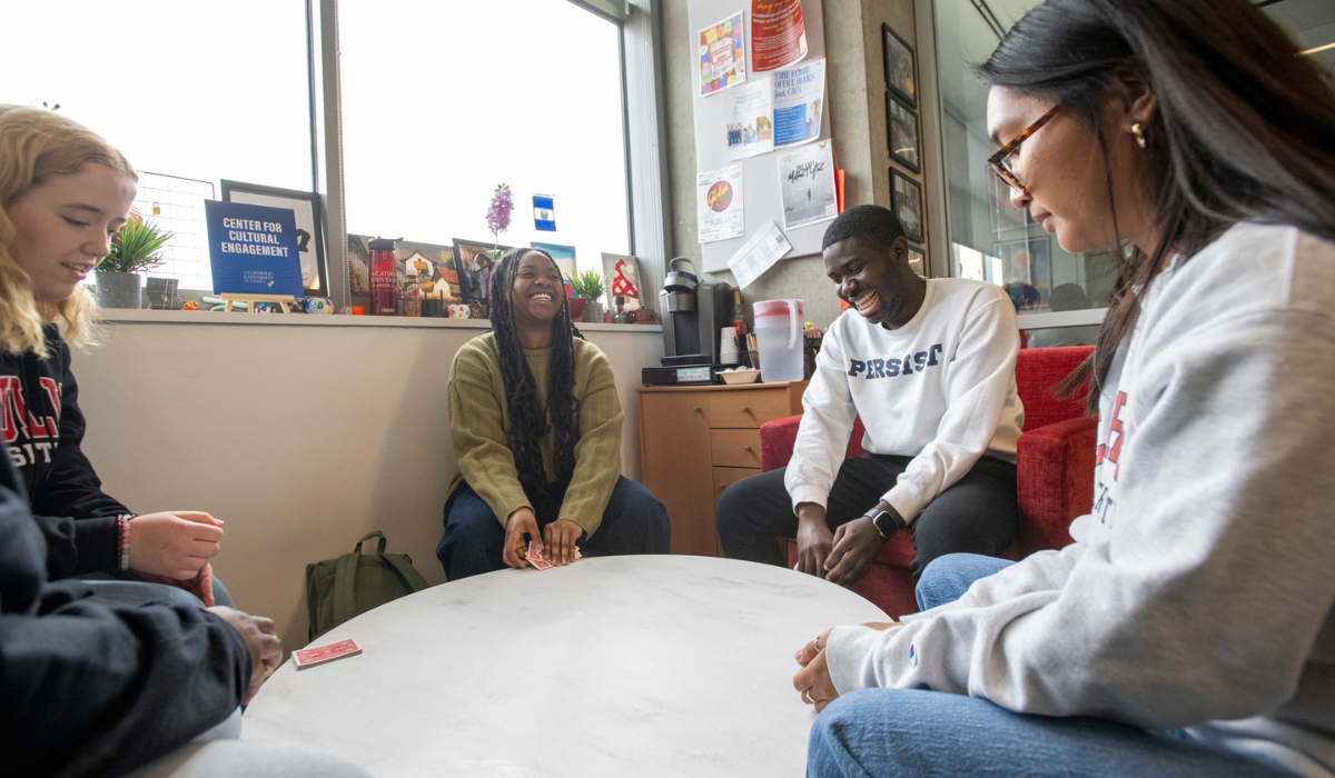 A group of students are chatting over a table at the Pryz.
