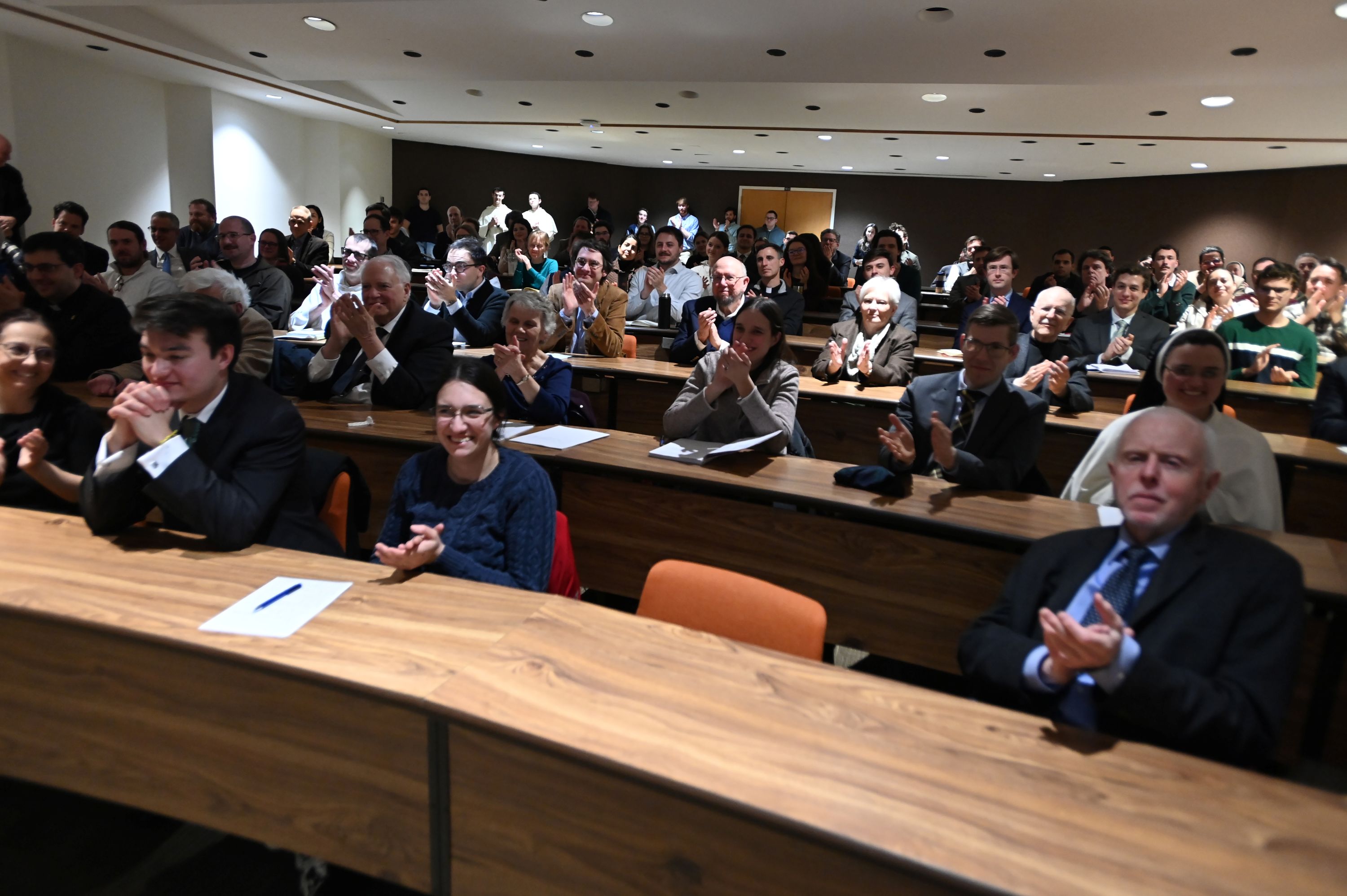 Crowd in Aquinas Hall auditorium applauds Prof. Michael Gorman's lecture