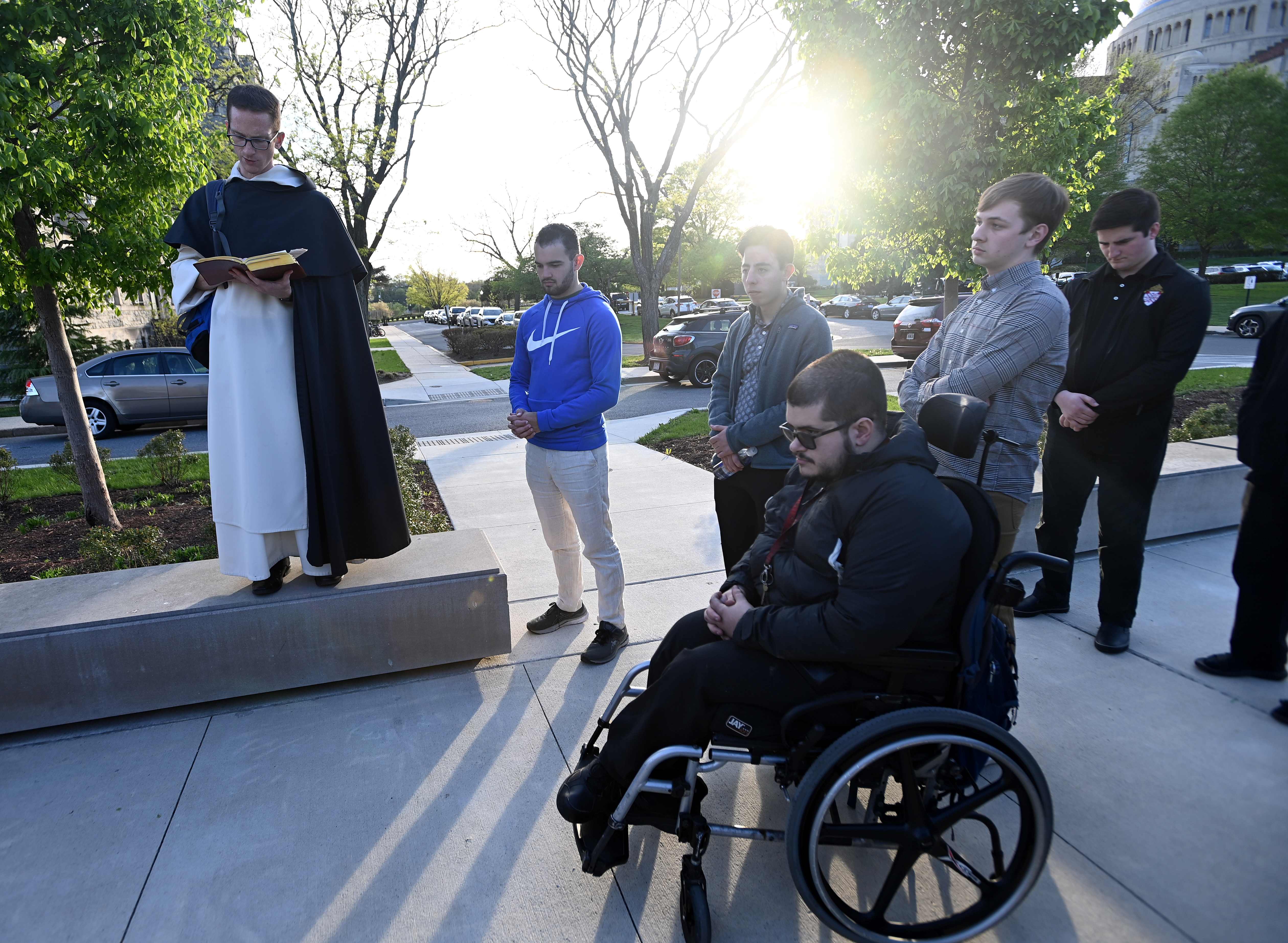 Anthony Curioso prays at the Welcome Plaza