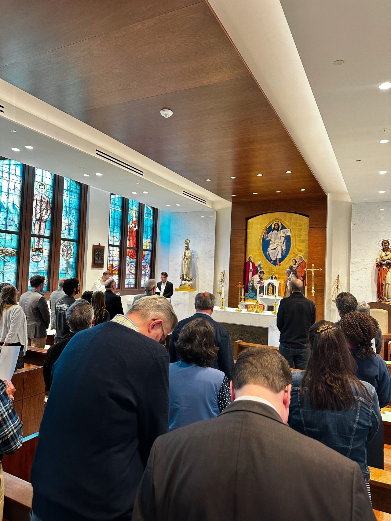 Faculty praying in St. Michael Chapel