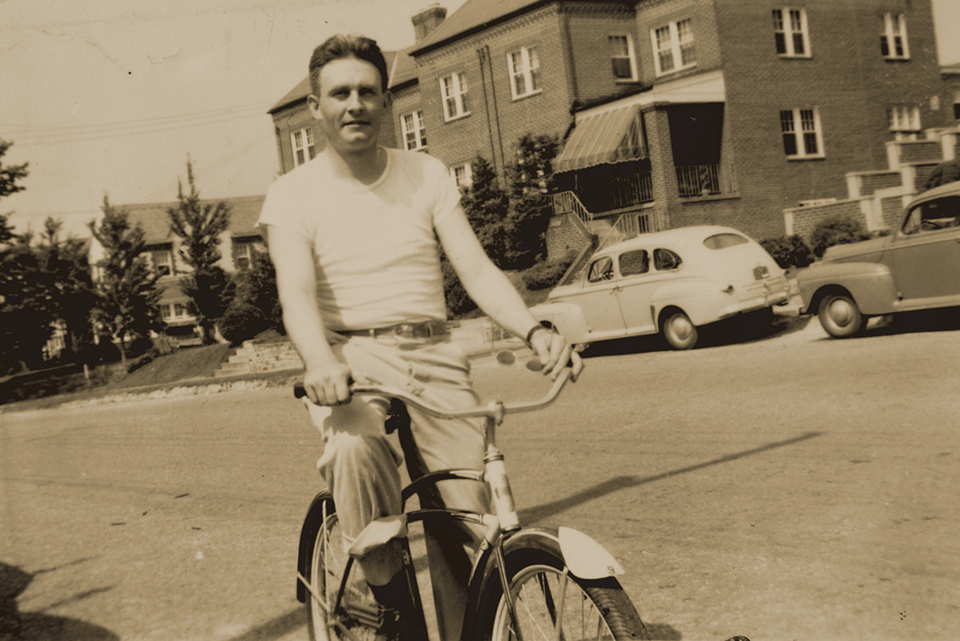 Fr. Emil Kapaun riding a bicycle