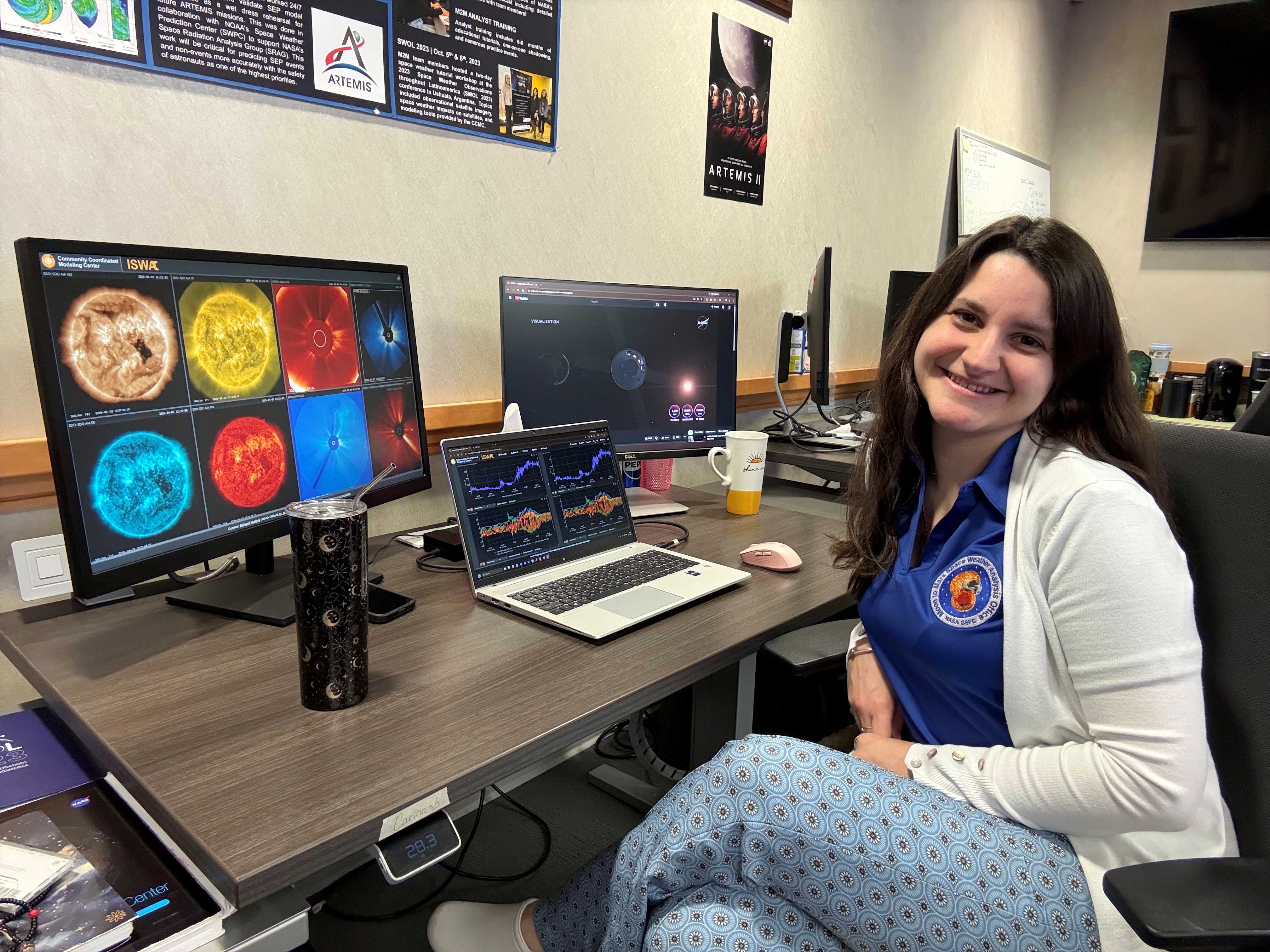 Carina Alden sits at her desk at the space weather office at NASA Goddard Space Flight Center