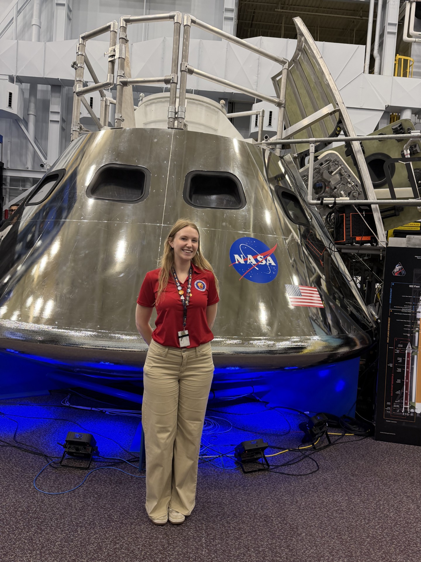 Melissa Kane stands outside a space landing capsule