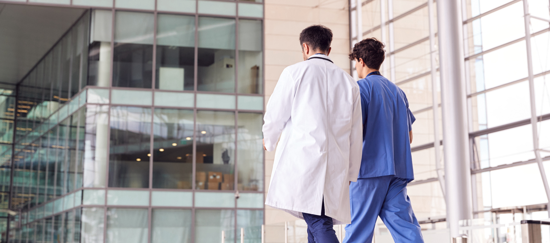 male doctor and nurse walking away to the hospital