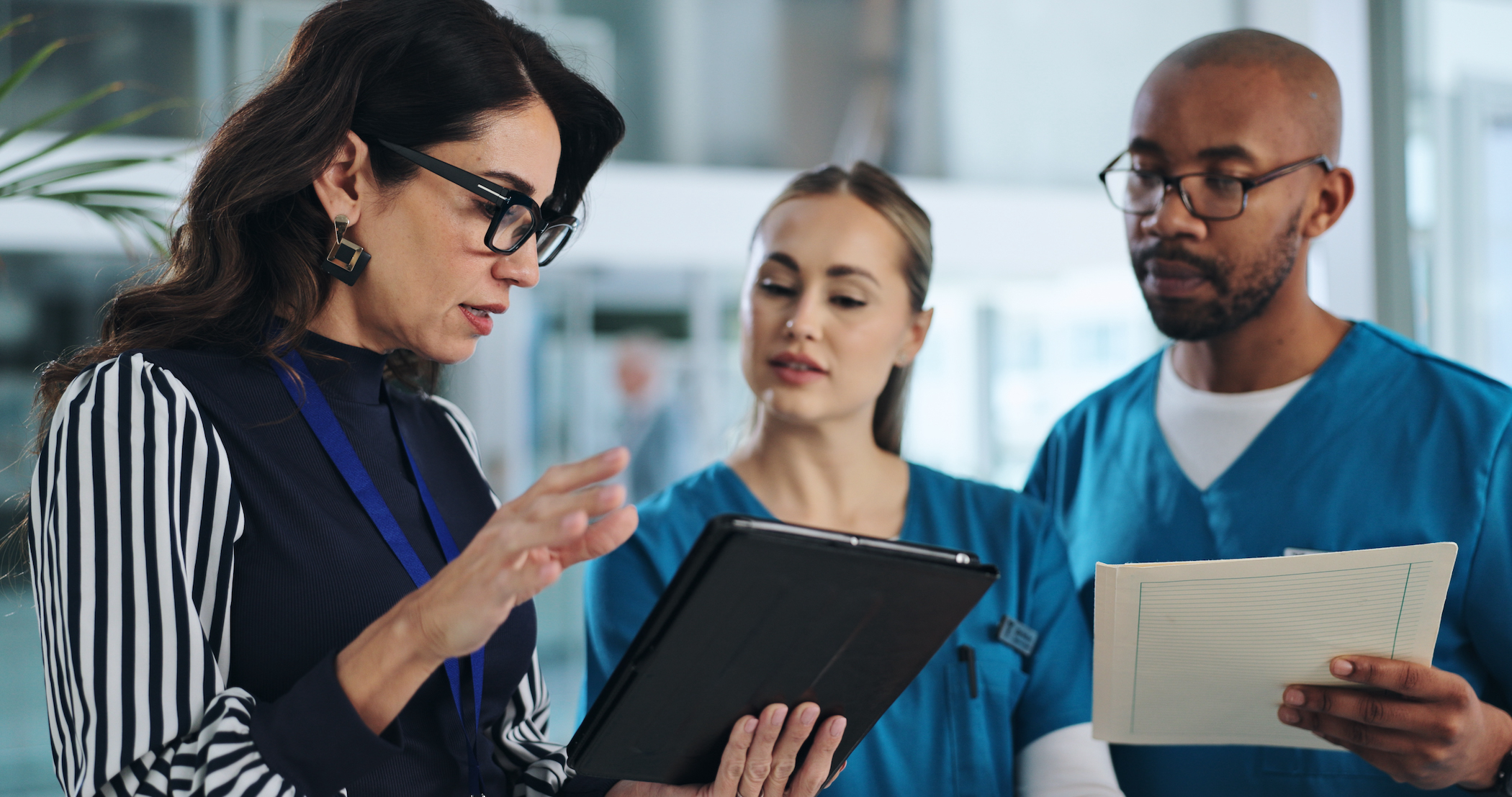 Executive in nursing planning with nurses in an office setting