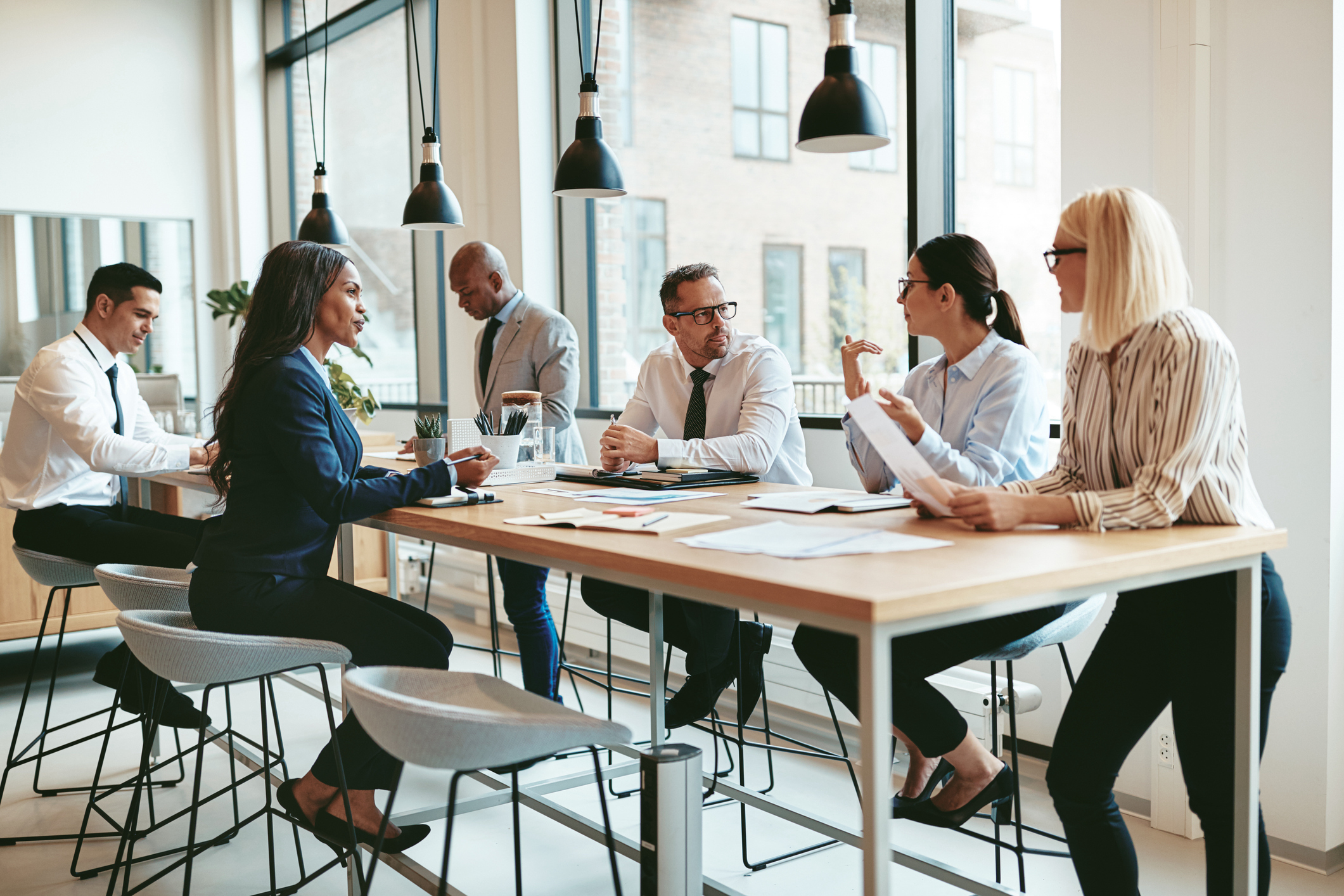 professional employees collaborating in an office at a long table