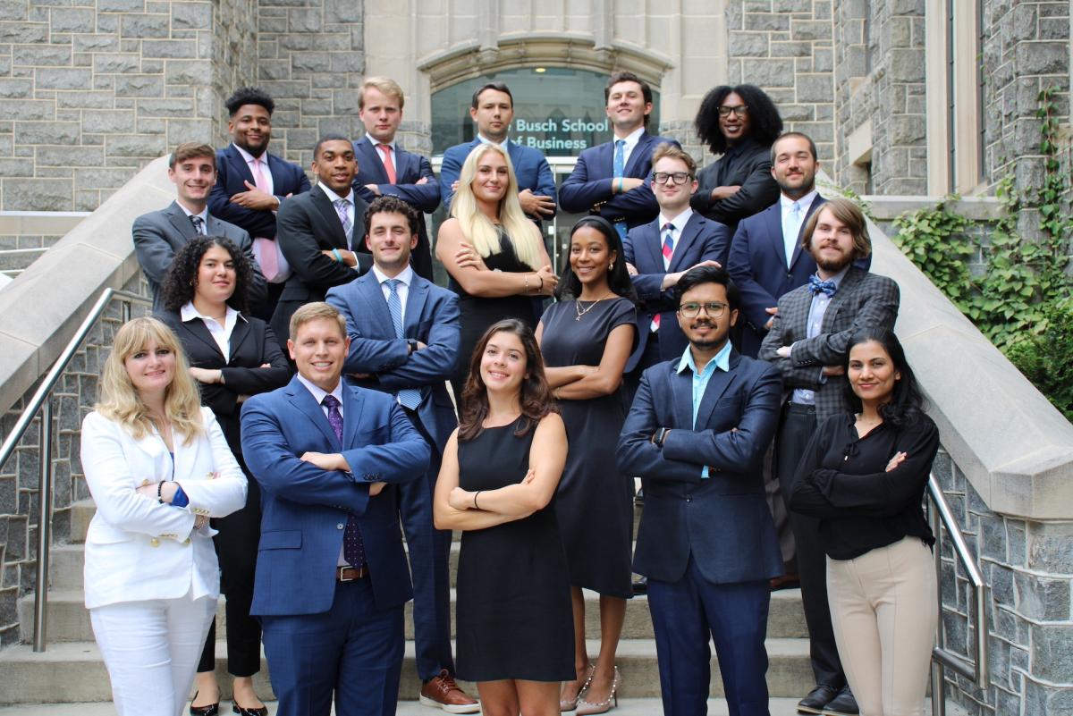 Busch School of Business students standing on the front steps of the School.