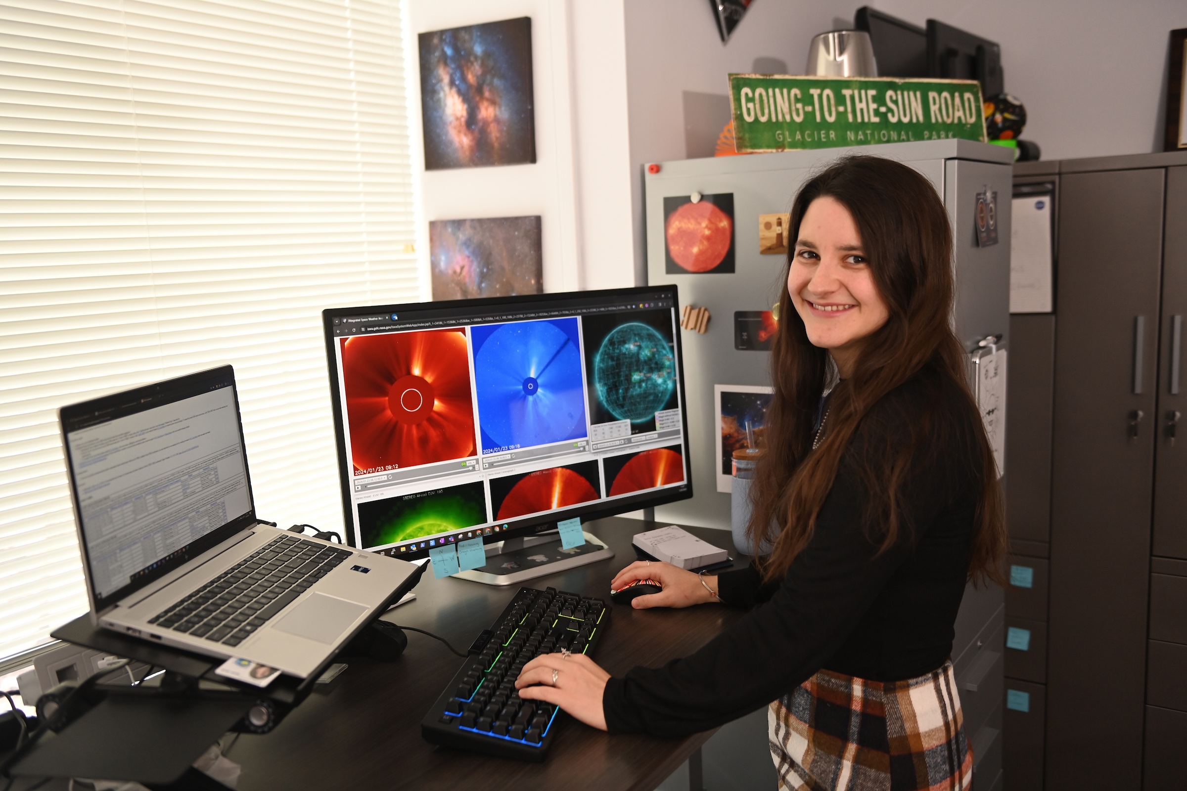 Carina Alden works at her desk at NASA’s Moon to Mars Space Weather Analysis Office.
