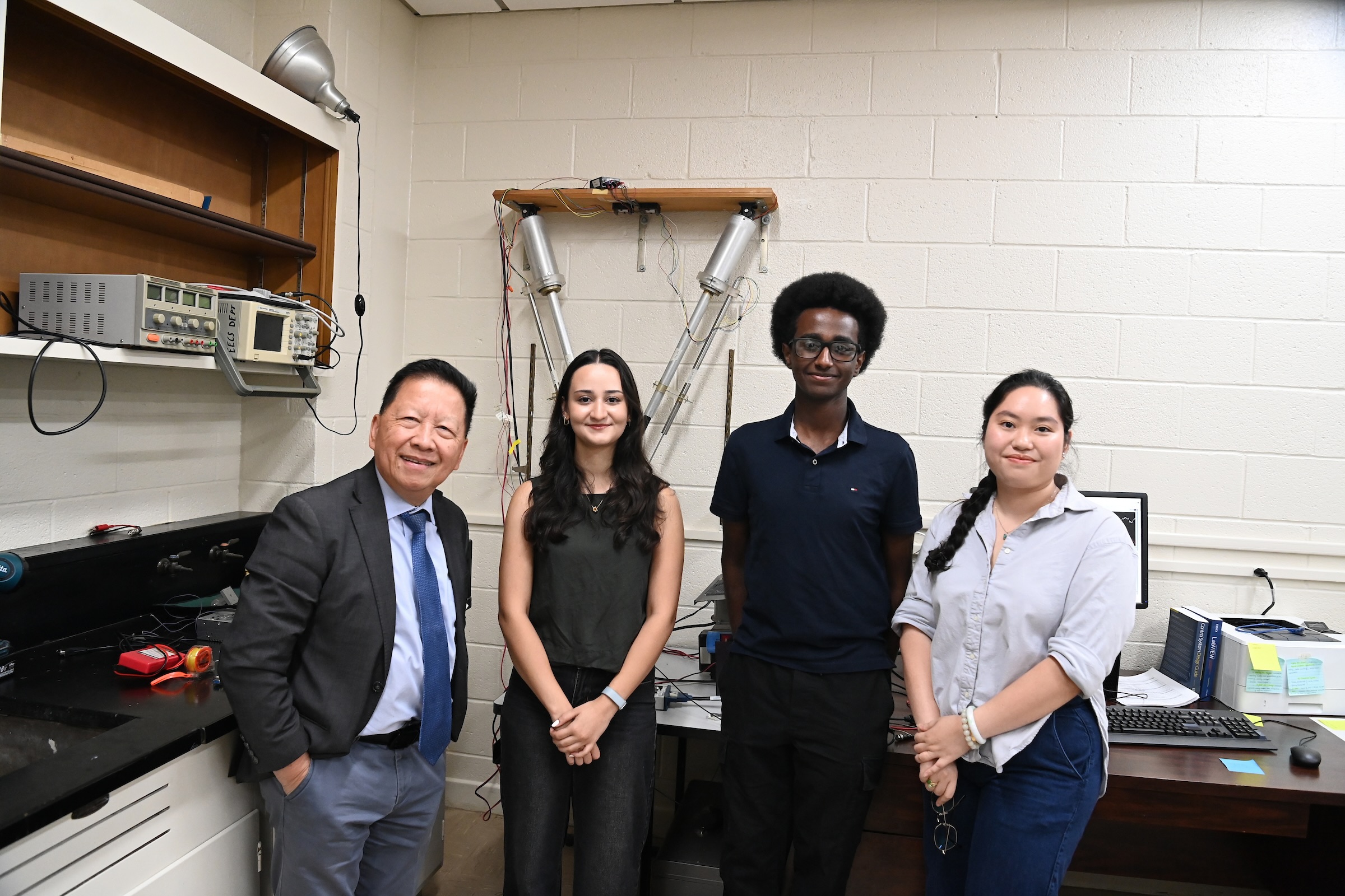 Charles Cuong Nguyen, engineering dean emeritus and professor, stands before his robot with his team of students, an undergraduate intern from Yale University Saliha Kavafogolu, Da Vinci Scholar Nathan Arega, and biomedical engineering doctoral candidate Ha (Jessica) Ngo-Tang