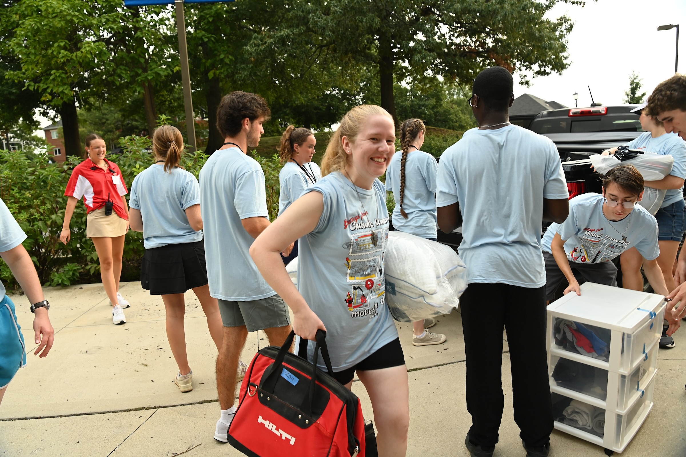 student moves bag from car