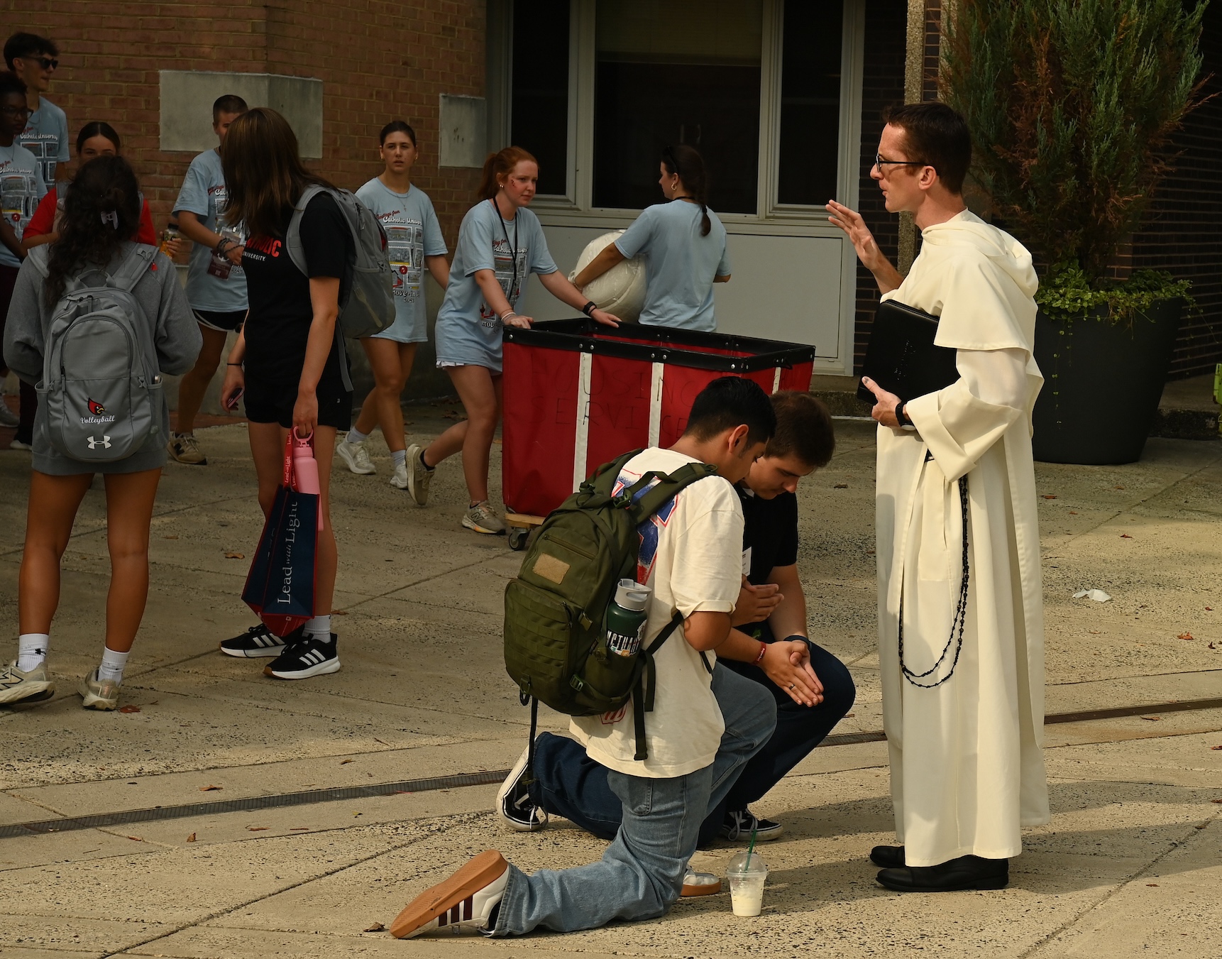 Fr. Bernard Knapke blesses students 
