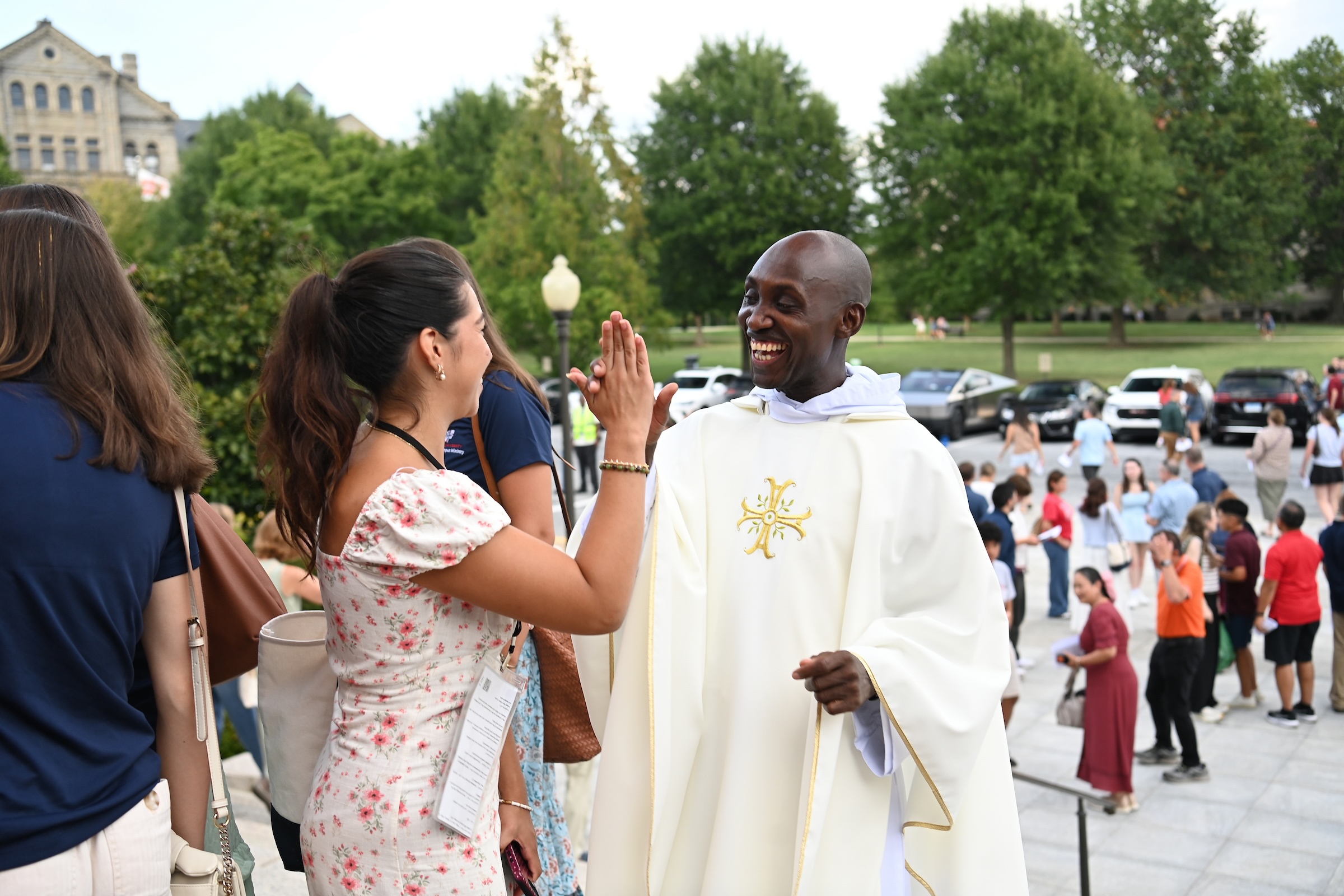 Father Gilbert Andama greets a new student