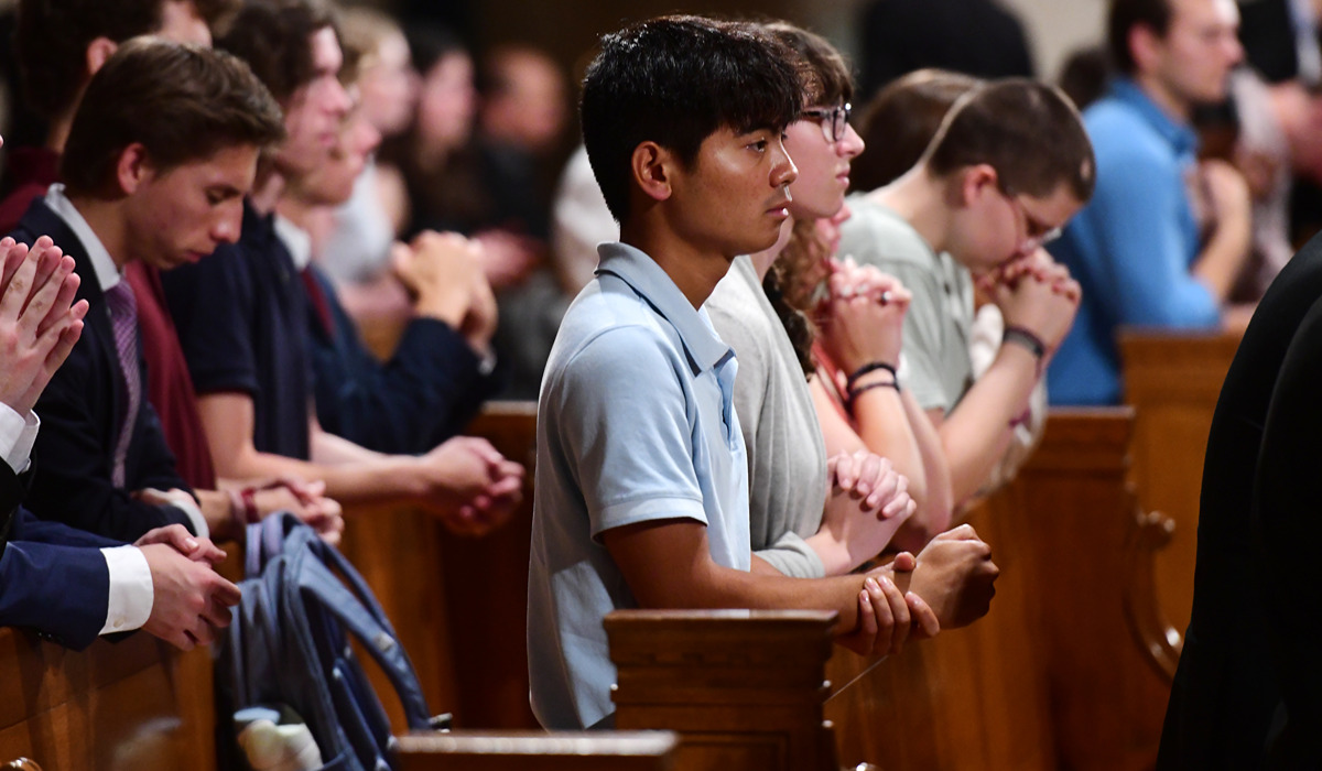 Students praying together in church