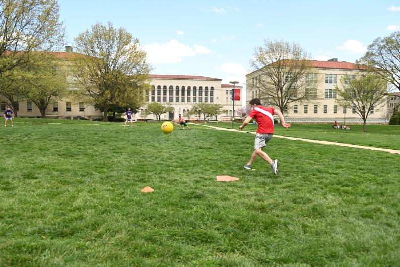 student playing kickball