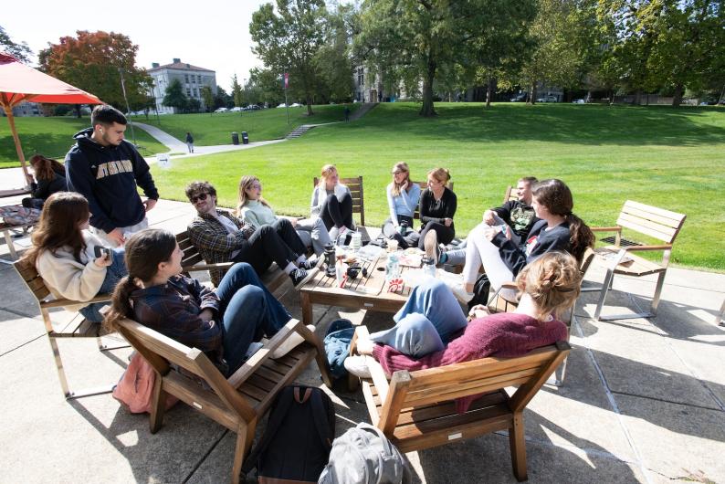students chatting in an outdoor space on campus