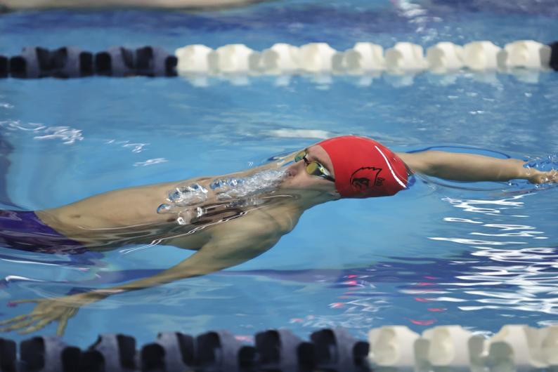 cua swimmer doing backstroke