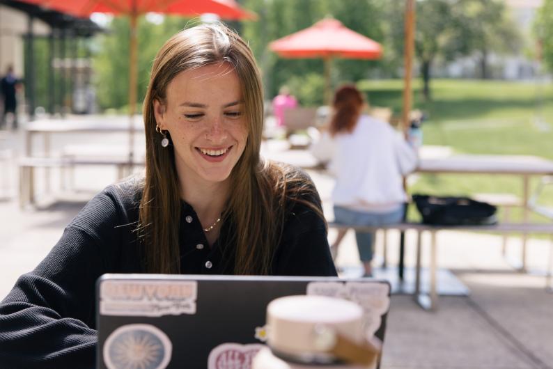 happy student working on laptop