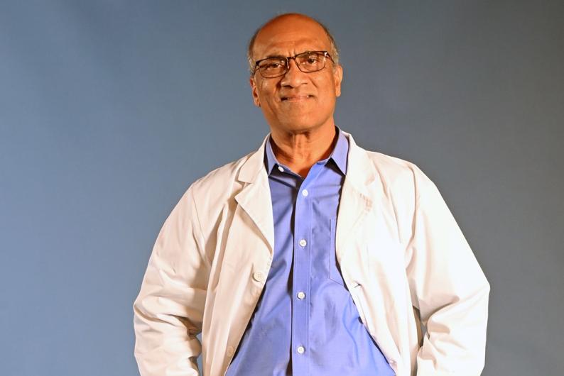 Dr. Rao in a lab coat