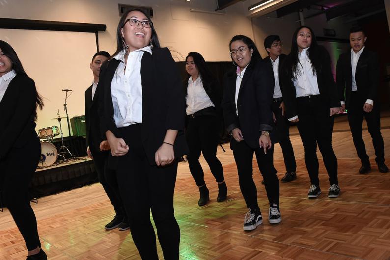 filipino students performing a dance on campus