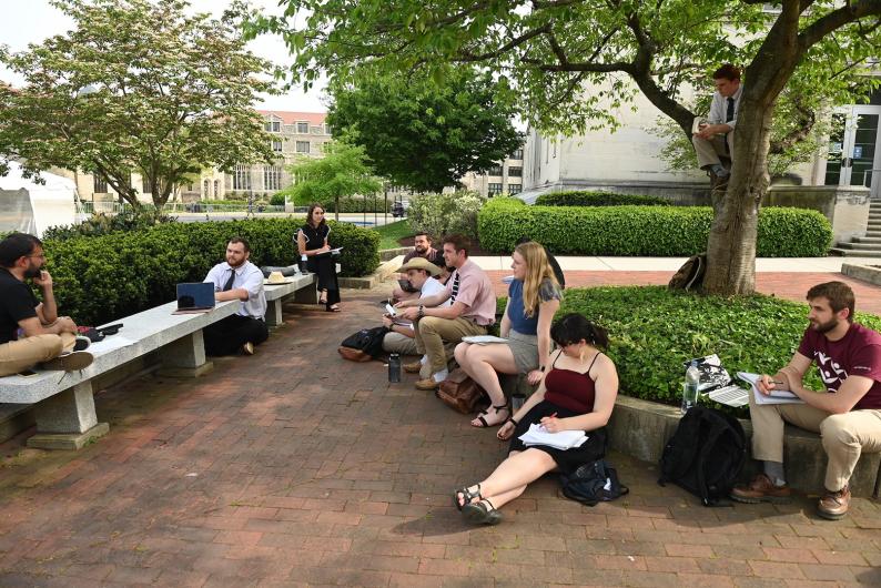 class being held outdoors on a plaza on campus