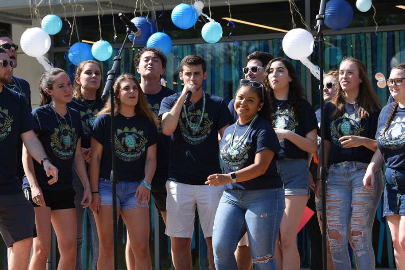 Students singing and performing on campus.