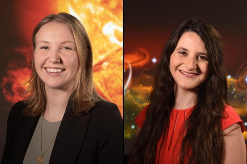 Two students from Catholic University's Space Weather program. The one on the left has blond hair and is wearing a black blazer over an olive shirt. The student on the right has long brown hair and is wearing a red blouse.