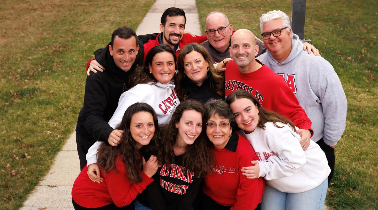 The Kilner family squeezes together for a family portrait on campus