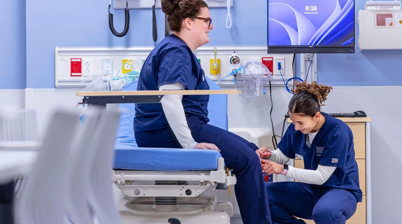 Nursing students practicing tests in a simulation lab.